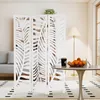 A white folding screen with a leaf pattern is placed in a room next to a dining table and a sofa. Anteprima dell’immagine prodotto