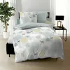 A bedroom scene with a bed dressed in a nature-themed duvet cover. Produktbild-Vorschau