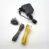 A collection of networking accessories, including a power adapter, a UK plug adapter, and two Ethernet cables, laid out on a white background. Podgląd zdjęcia produktu