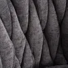 A close-up view of the tufted fabric upholstery of a chair or stool. Produktbild-Vorschau