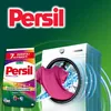 A washing machine with a pink t-shirt being pulled out, next to a box of Persil laundry detergent. Náhled obrázku produktu