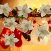 Christmas decorations on a fireplace mantel with stockings and lights. Produktbild-Vorschau