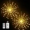 Two starburst-shaped string lights with warm white LEDs against a dark background, with a remote control and battery pack shown in the lower left corner. Produktbild-Vorschau