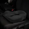 A black orthopedic seat cushion is placed on a black car seat. Podgląd zdjęcia produktu