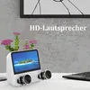 A white portable DVD player with a screen displaying a tropical island scene, placed on a white desk next to a laptop and a small potted plant with pink flowers. The background is a textured gray wall. Náhľad obrázku produktu