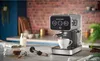 An espresso machine is shown on a kitchen counter, with a cup of coffee and coffee beans nearby. Produktbild-Vorschau