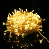 A coiled string of yellow LED lights on a black reflective surface. Produktbild-Vorschau