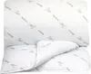 A white comforter with a repeating pattern of bamboo stalks and the word "Bamboo" printed in green. Produktbild-Vorschau