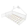 A white wooden children's bed with a house-shaped frame and a fence-like railing, shown from a slightly elevated angle with one side of the railing open like a gate. Podgląd zdjęcia produktu