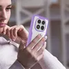 A woman is holding and looking at a smartphone with a purple case. Produktbild-Vorschau