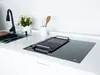 A modern kitchen countertop with a sink and a black induction cooktop. Náhľad obrázku produktu