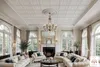 A luxurious living room with ornate ceiling panels, a grand chandelier, and large arched windows. Produktbild-Vorschau
