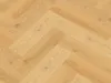 A close-up, overhead view of a herringbone-patterned wooden floor. Produktbild-Vorschau
