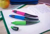 Three STABILO pens are placed on an open notebook with handwritten text, next to an apple and a pencil case. Anteprima dell’immagine prodotto