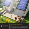 A backyard scene with a house, deck, and outdoor furniture, featuring a gray sun sail. Produktbild-Vorschau