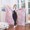 A young girl is holding up a unicorn-themed blanket in a bedroom. Náhľad obrázku produktu