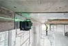 A construction worker on a scaffold uses a laser level to measure a ceiling in an unfinished building. Náhľad obrázku produktu