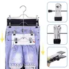 A multi-tiered hanger with clips holding various garments like pants and shorts. Produktbild-Vorschau