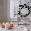 A table setting with lit candles and wine glasses, decorated for a festive occasion. Produktbild-Vorschau