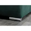 Close-up of the bottom corner of a green sofa with a silver leg on a wooden floor. Produktbild-Vorschau