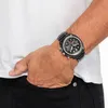 A person's arm wearing a watch, with their hand in their pocket. Anteprima dell’immagine prodotto