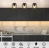 A modern kitchen with black cabinets and a tiled backsplash, featuring three black vintage-style ceiling lights. Náhľad obrázku produktu