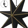 A close-up of a black star-shaped decoration with gold trim. Produktbild-Vorschau