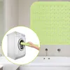 A collage showing a green bath mat and a person putting a bath mat into a washing machine. Produktbild-Vorschau