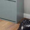 A close-up view of a gray shoe cabinet and a black bag on a wooden floor. Náhled obrázku produktu