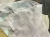 Close-up of a sheer curtain with a floral pattern. Produktbild-Vorschau