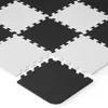 A close-up, angled view of interlocking foam puzzle mats in a black and white checkerboard pattern. Náhled obrázku produktu