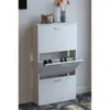 A white shoe cabinet with three flip-down drawers, one of which is open, revealing shoes inside. A brown handbag and a vase with orange flowers are on top of the cabinet. Voir les images du produit