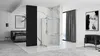 A modern bathroom with a shower cabin, bed, and armchair, suggesting a combined living and bathing space. Produktbild-Vorschau