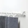 A white curtain rod with rings and gray curtains attached, mounted on a white wall. Voir les images du produit