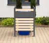 A trash can enclosure with a blue bin inside, placed on a paved patio in front of a building. Náhled obrázku produktu