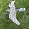 A grey bird decoy is hanging in a grassy area. Náhled obrázku produktu