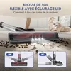Close-up of a vacuum cleaner head with LED lights illuminating debris on a floor, with a child and dog in the background. Insets show different articulation angles. Voir les images du produit