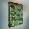 A folded camouflage tarp is shown against a gradient background. Produktbild-Vorschau