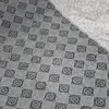 A close-up view of the underside of a rug, showing a checkered pattern of small dots and a textured fabric area. Náhled obrázku produktu