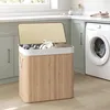 A laundry basket filled with clothes in a laundry room next to a washing machine.