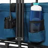 Close-up view of the side of a blue folding wagon, showing storage pockets with a walkie-talkie and a water bottle. Voir les images du produit