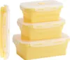 A set of three stackable yellow silicone food storage containers with white lids, shown from the front and side. Podgląd zdjęcia produktu