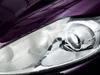 A close-up shot of a car headlight and the surrounding purple car body. Podgląd zdjęcia produktu