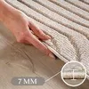A hand is shown pressing down on a beige rug, demonstrating its softness and thickness. A close-up inset shows the rug's texture and a measurement indicating 7mm thickness. Podgląd zdjęcia produktu