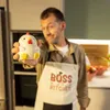 A man in a kitchen holding a stress toy. Voir les images du produit
