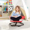 A young girl is sitting on a red swivel chair in a child's playroom, reading a book. Produktbild-Vorschau