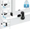 Close-up view of a white safety gate with black locking mechanisms, showing how to attach or detach it. Náhľad obrázku produktu