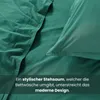 Close-up of green bedding with text overlay. Produktbild-Vorschau