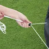 A hand is holding a white cord attached to a black object, possibly a pool cover, on a grassy surface. Produktbild-Vorschau