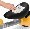 A child's hand touching the seat of a balance bike. Anteprima dell’immagine prodotto